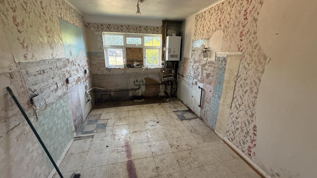 Lot: 29 - SEMI-DETACHED BUNGALOW IN NEED OF REFURBISHMENT - Internal image of kitchen from hallway